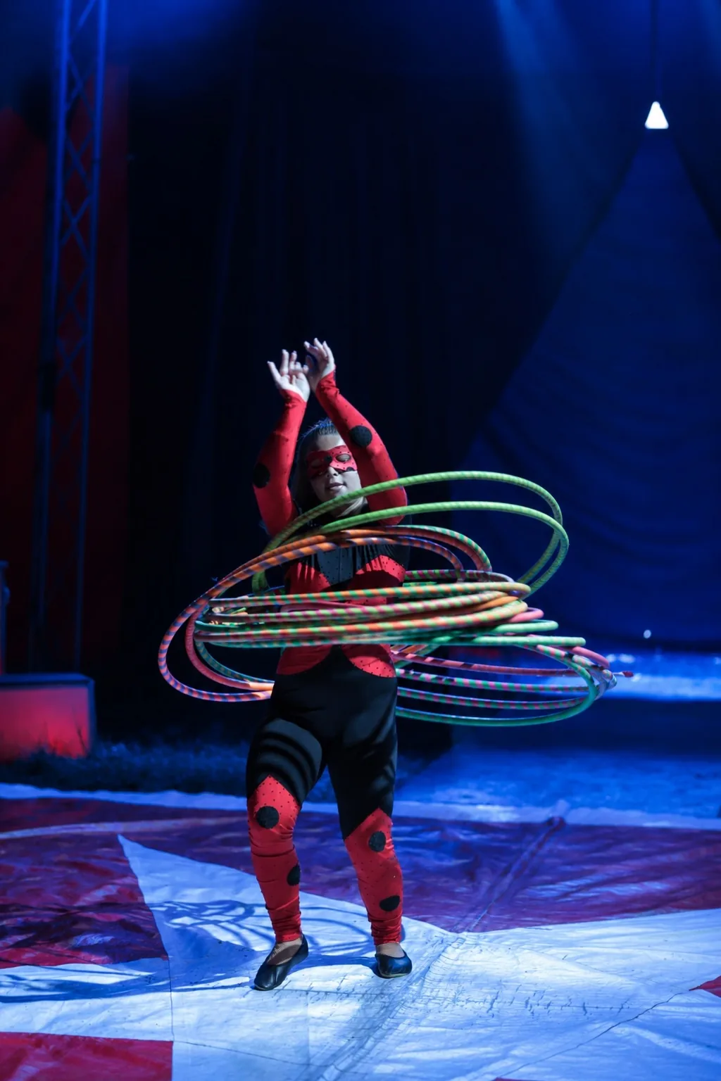Artistin wirbelt zahlreiche Hula-Hoop-Reifen gleichzeitig